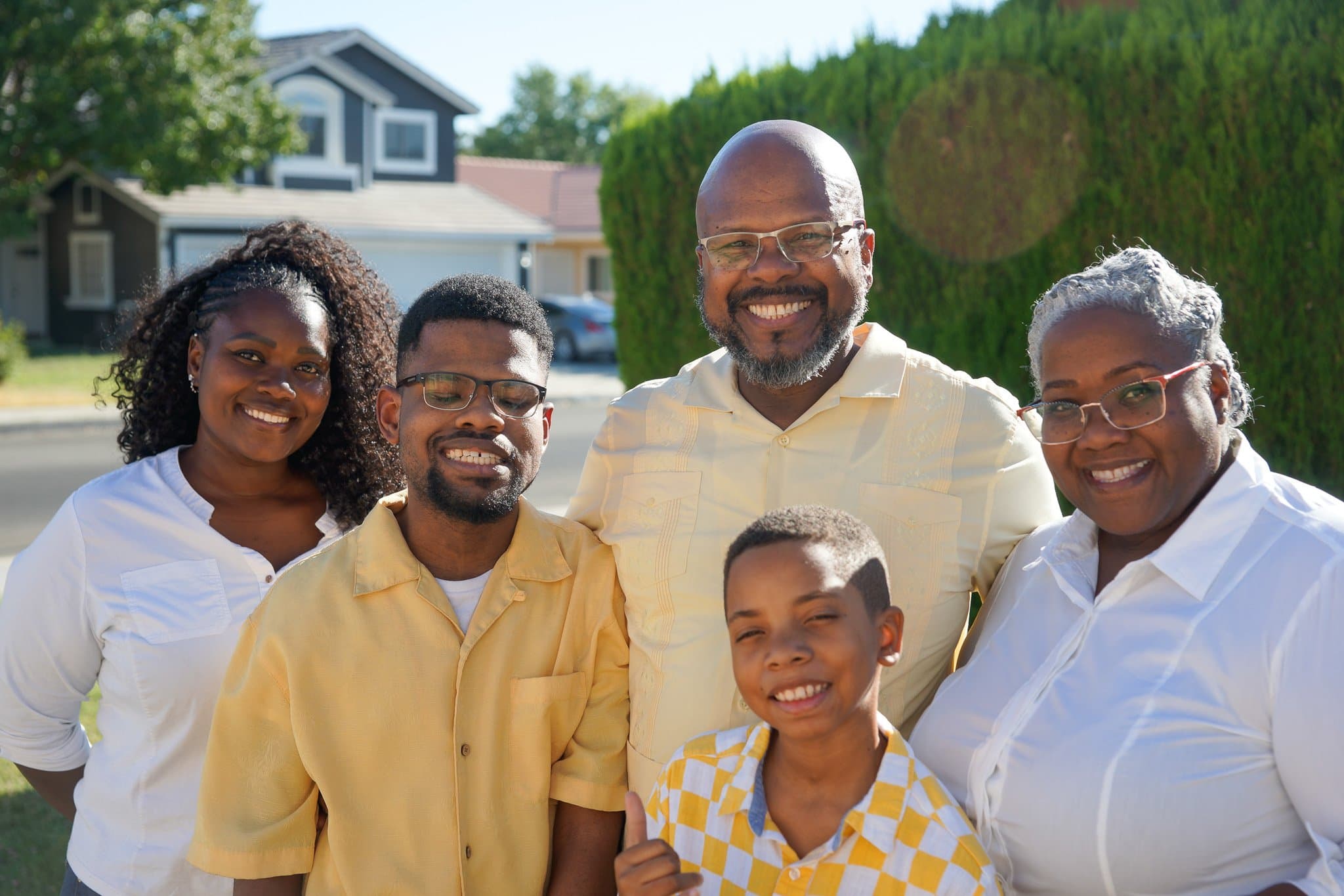 Jarrett (center) smiling, with his family: mother Athena, father Willie, brother Jorell, and sister Jewelmani. 